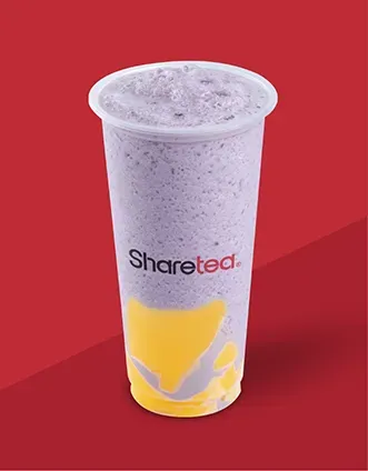 Clear plastic drink cup with purple blended beverage and yellow fruit graphic on a red background