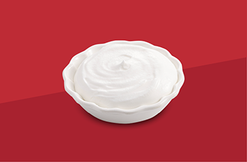 White meringue dessert on a red background