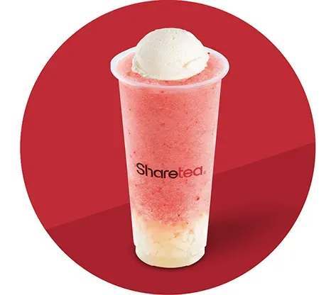 Pink-and-white smoothie in a clear cup with a scoop of ice cream on top, on a red background