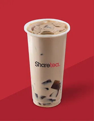 Tall iced milk tea in a clear cup on a red background, with the logo “Sharetea” on the side.
