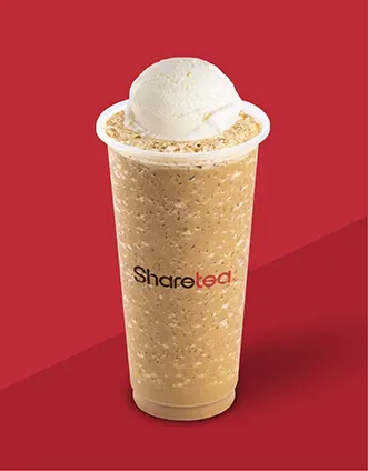 Tall beige milk tea with a scoop of ice cream on top against a red background