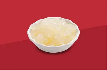 Small white bowl filled with translucent yellow jelly on a red background