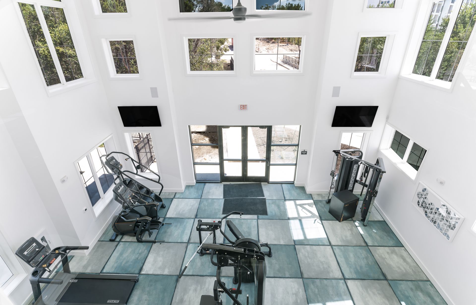 An aerial view of a gym with treadmills and exercise equipment at The Bennett, which offers apartments for rent in South Austin, TX.