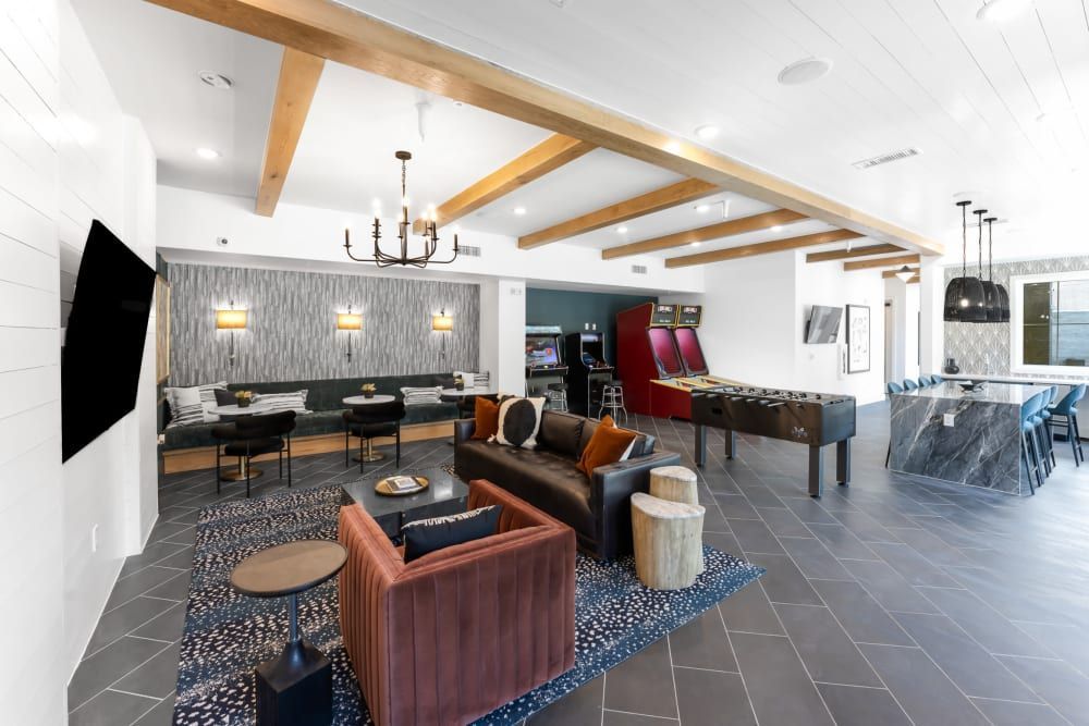 Clubhouse filled with furniture and a television at The Bennett, which offers apartments for rent in South Austin, TX.