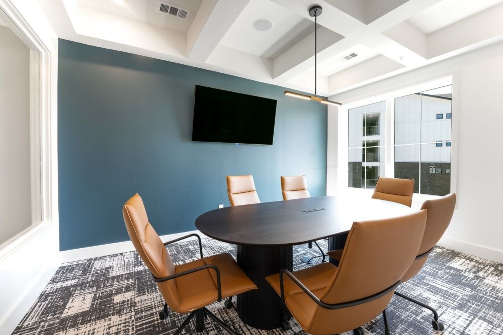 Conference Room with table, chairs, and TV at The Bennett, which offers apartments for rent in South Austin, TX.