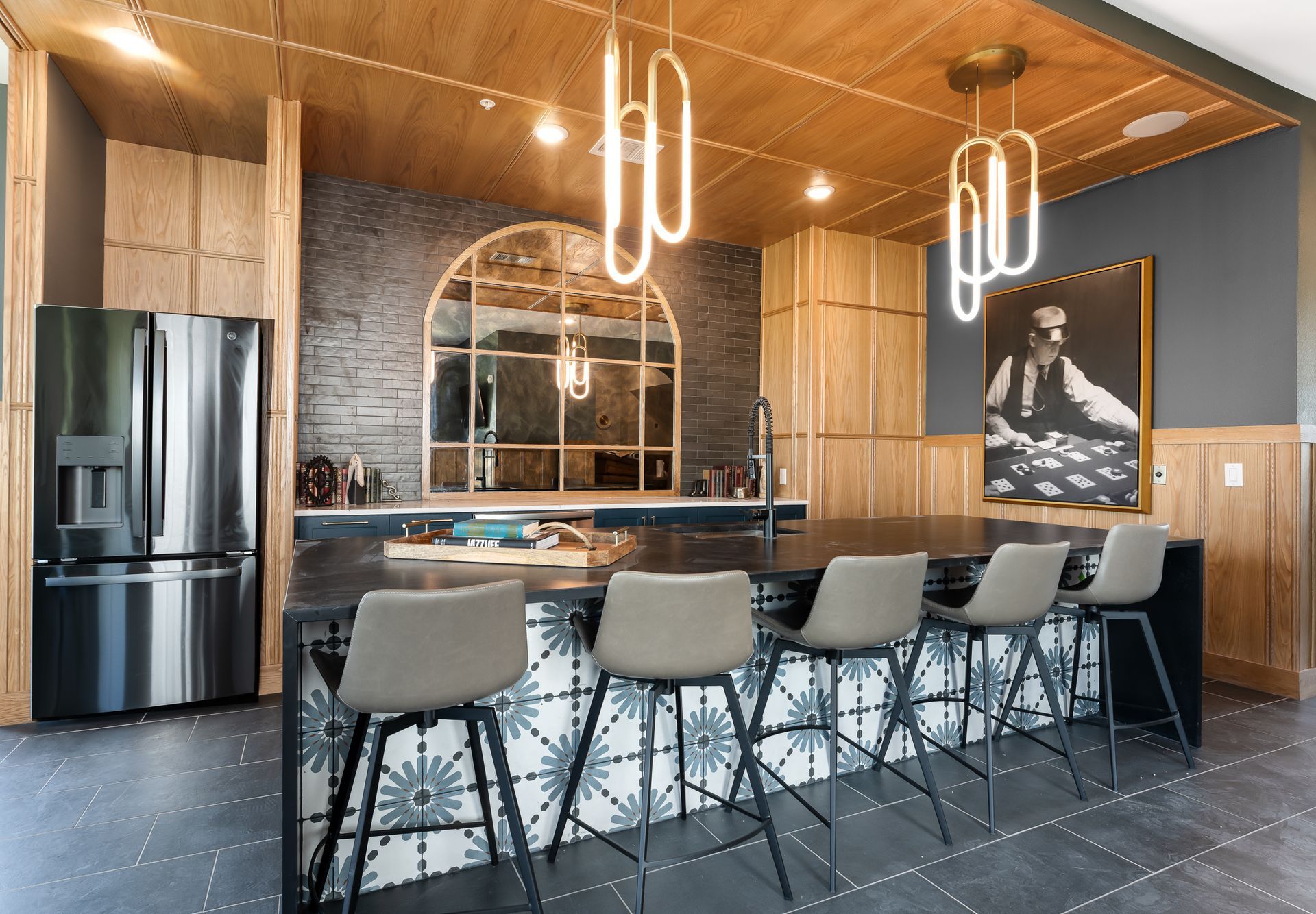 Community kitchen with a stainless steel refrigerator and a large counter top at The Bennett, which offers apartments for rent in South Austin, TX.