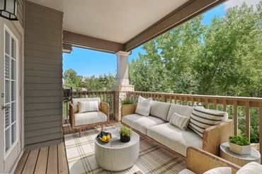 Round coffee table, and trees beyond the wooden railing Sequoia West Coast Multifamily Property Management.