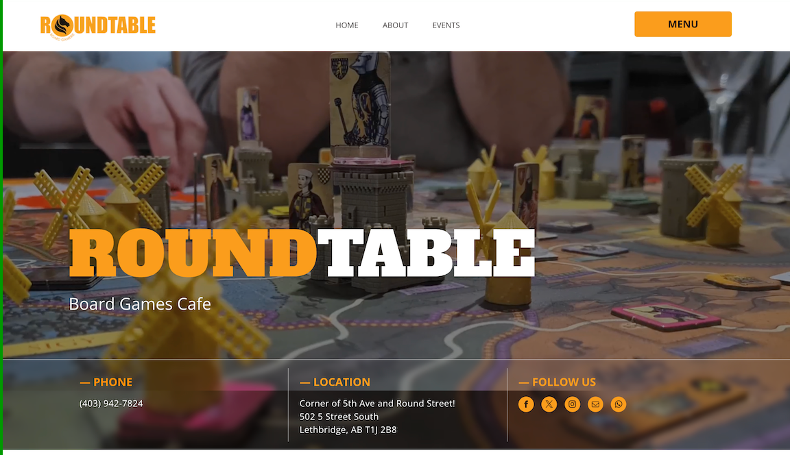 Board game group at a table with large “ROUND TABLE” title and website-style overlay text