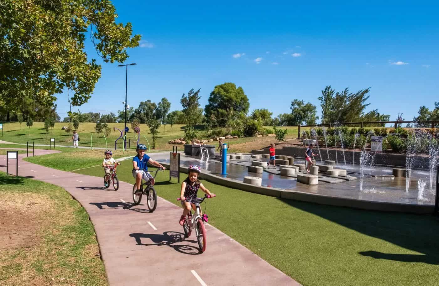 A Group Of Children Are Riding Bikes On A Path In A Park - Appliance Repairs in Tamworth, NSW