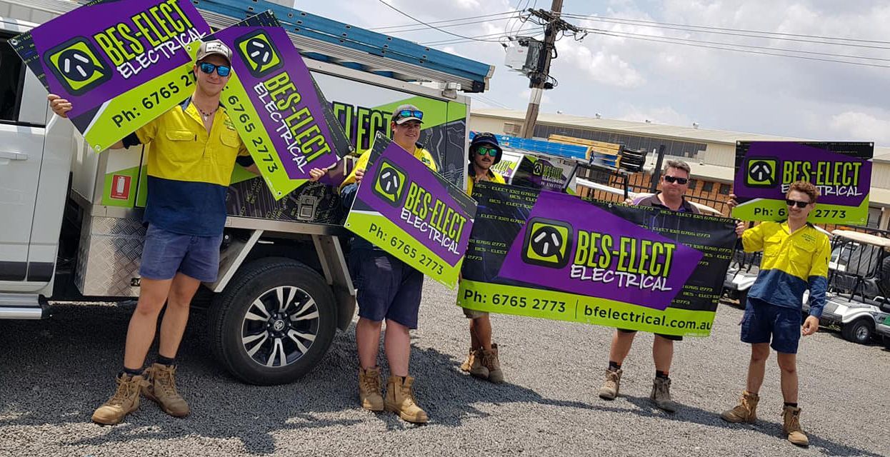 People Standing Near Work Truck Holding Signs For