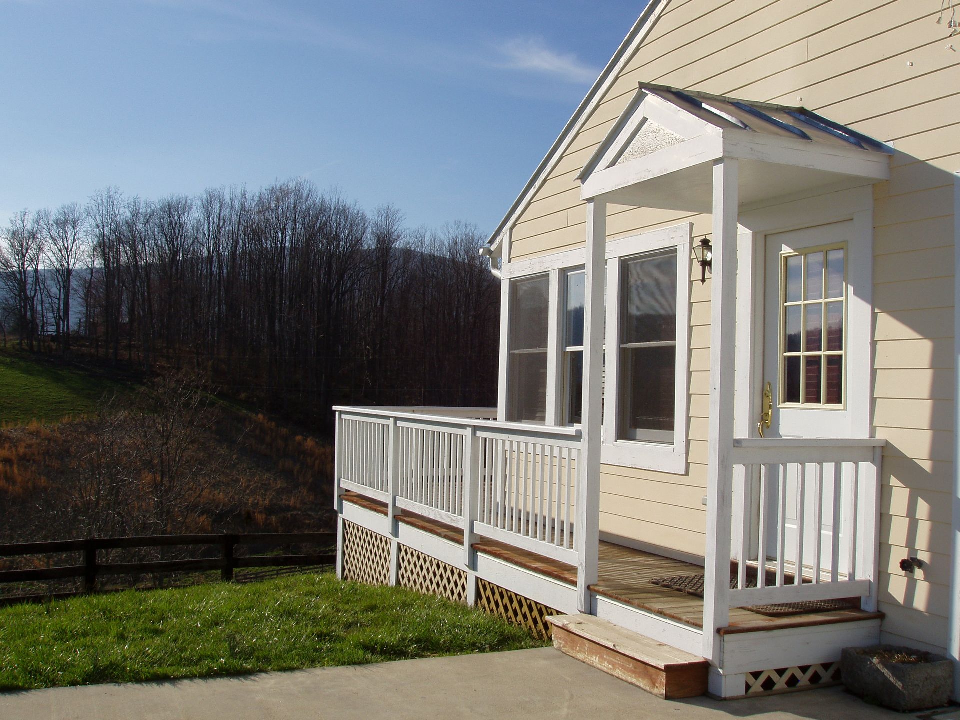 A house with a porch and a fence in the background