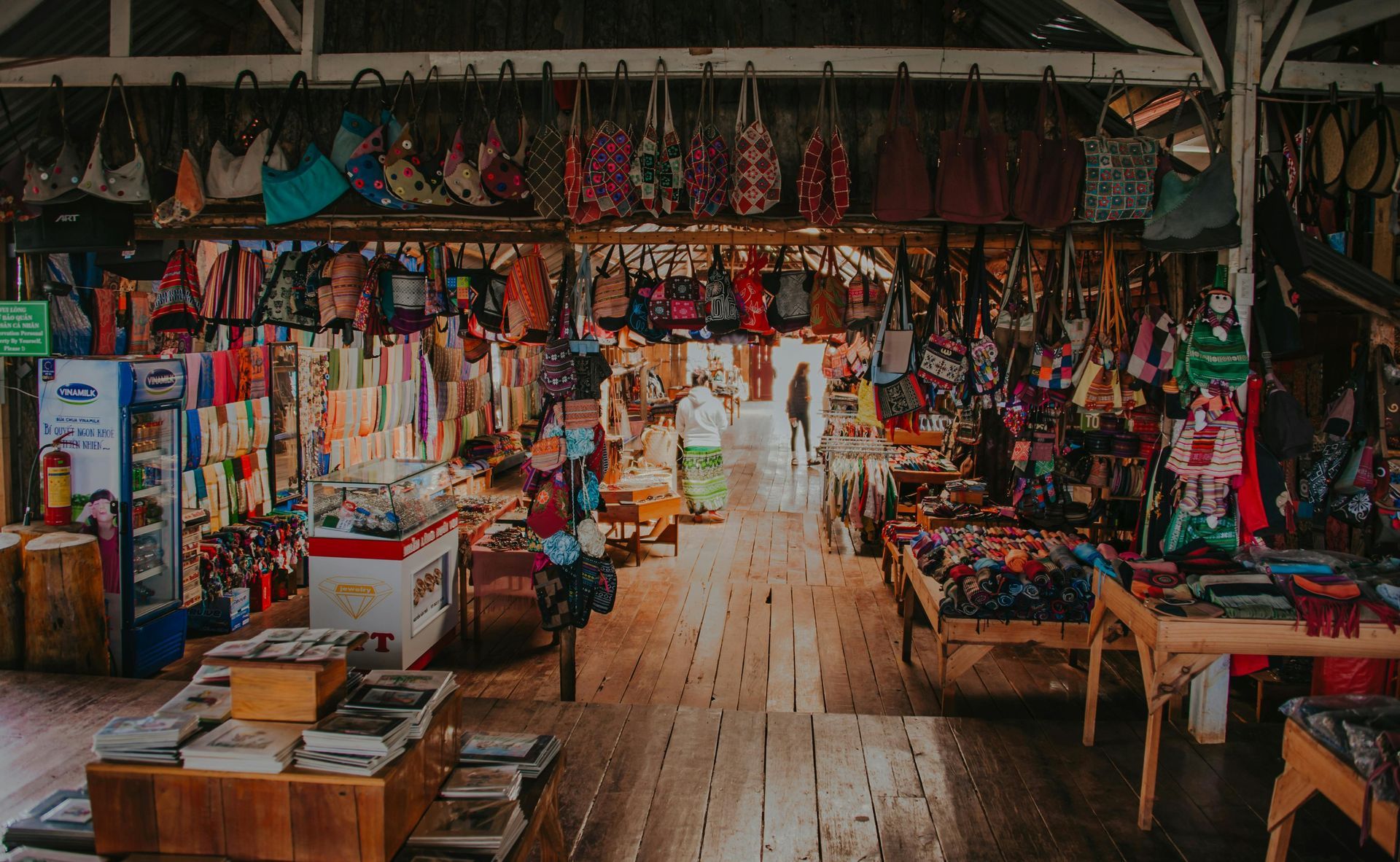 A market filled with lots of colorful items and tables.