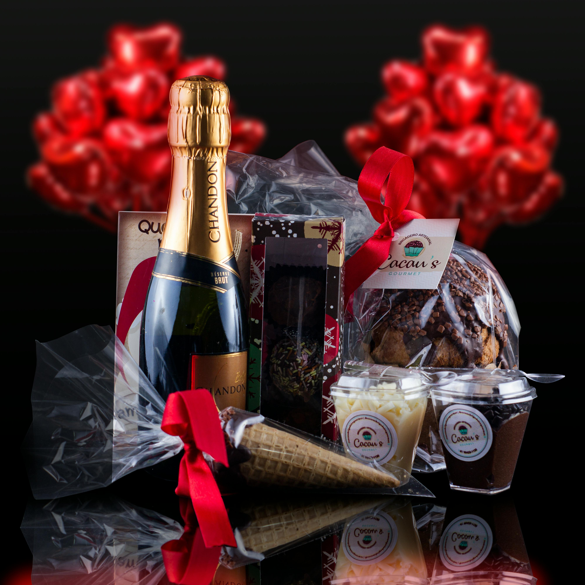 A bottle of champagne is surrounded by chocolates and ice cream cones