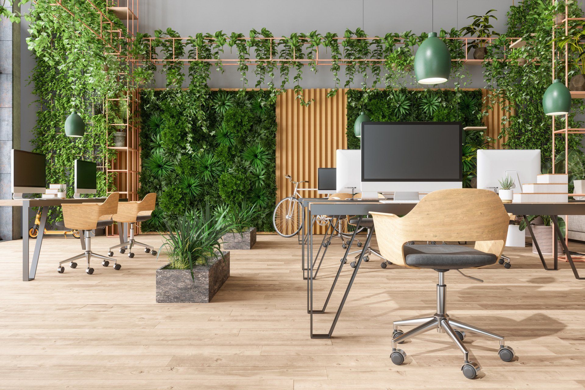 A modern office with lots of plants and tables and chairs.