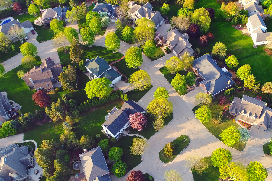 A house with a lush green lawn in front of it.