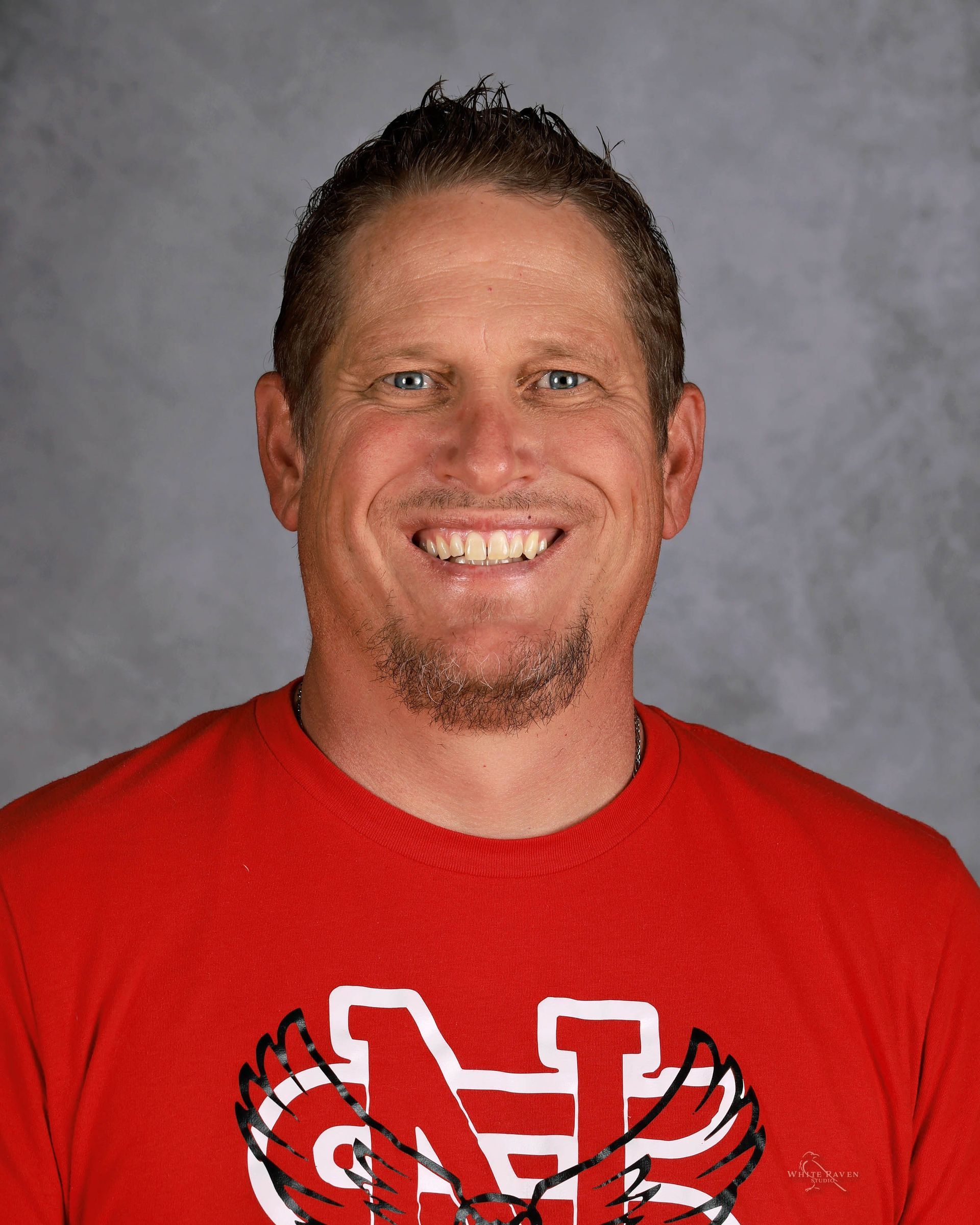Smiling man in red shirt with 
