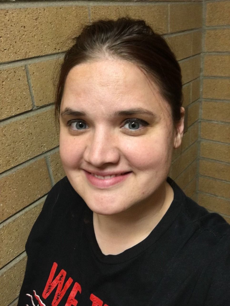 A woman wearing a black shirt with the word love on it