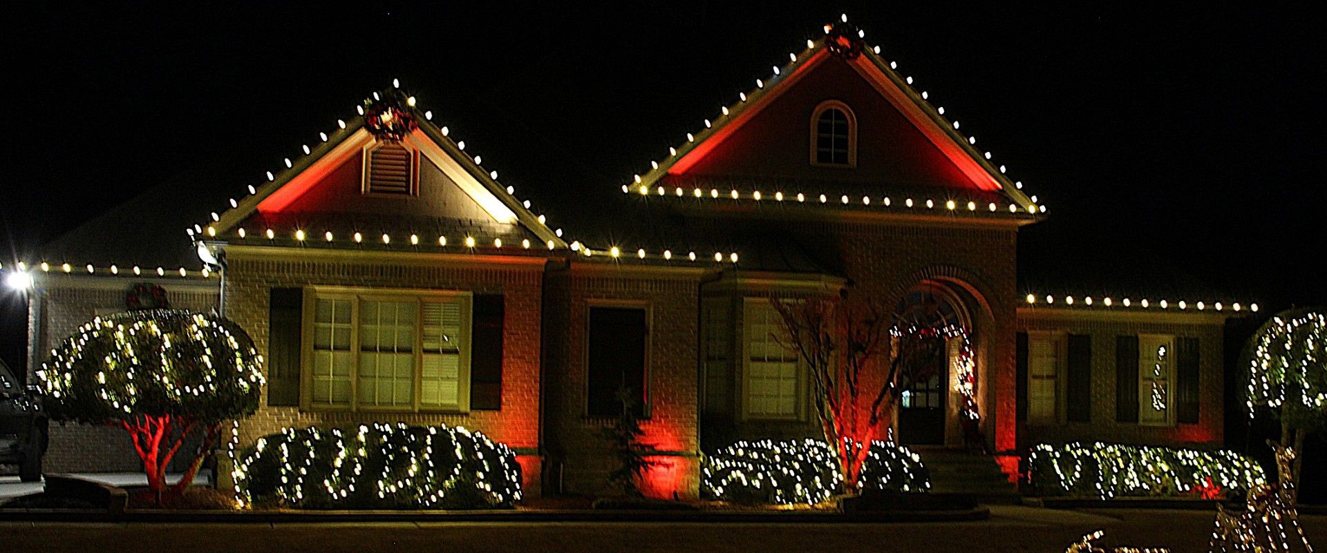 Permanent roofline lighting on a North Georgia home at dusk