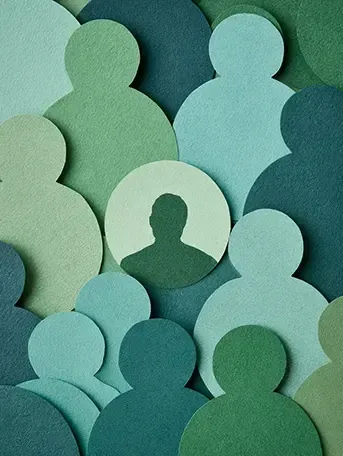 Layered paper cutouts of people silhouettes in shades of green, teal, and blue. A solo circle cutout holds the silhouette of a fractional marketing consultant denoting their ability to provide financial value through range and scale.