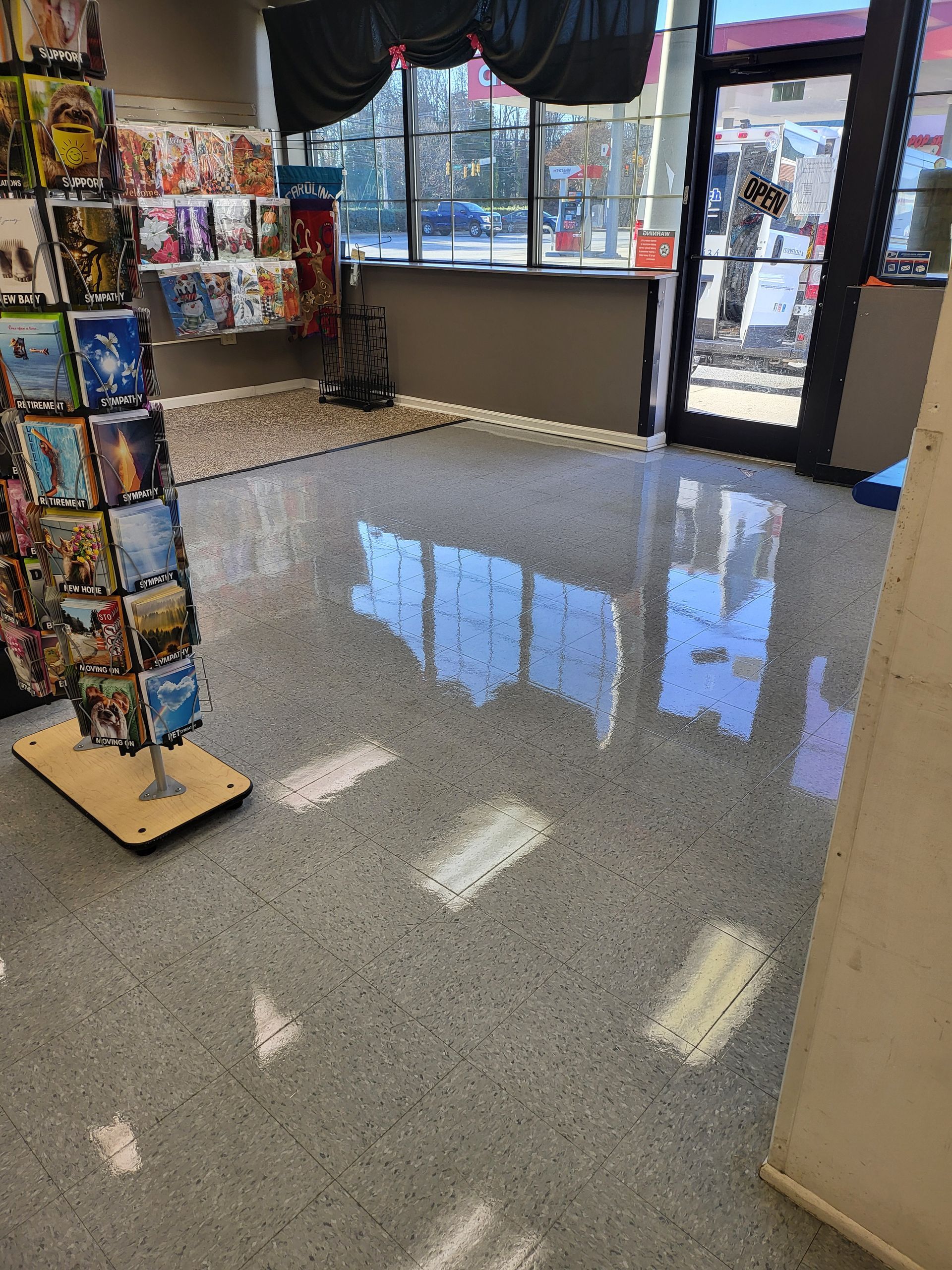 A store with a display of greeting cards on the floor