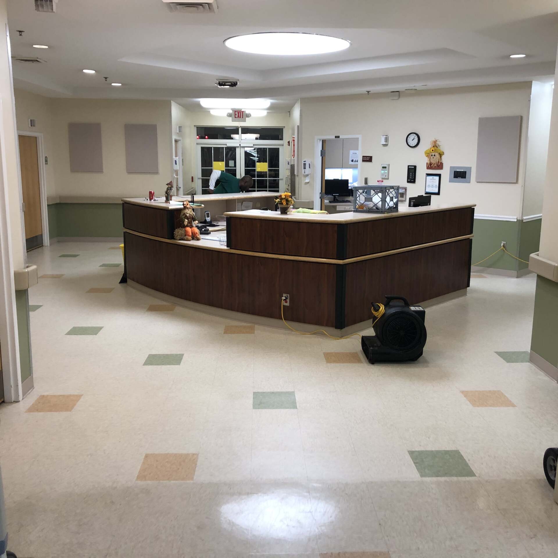 A hospital reception area with a large wooden counter