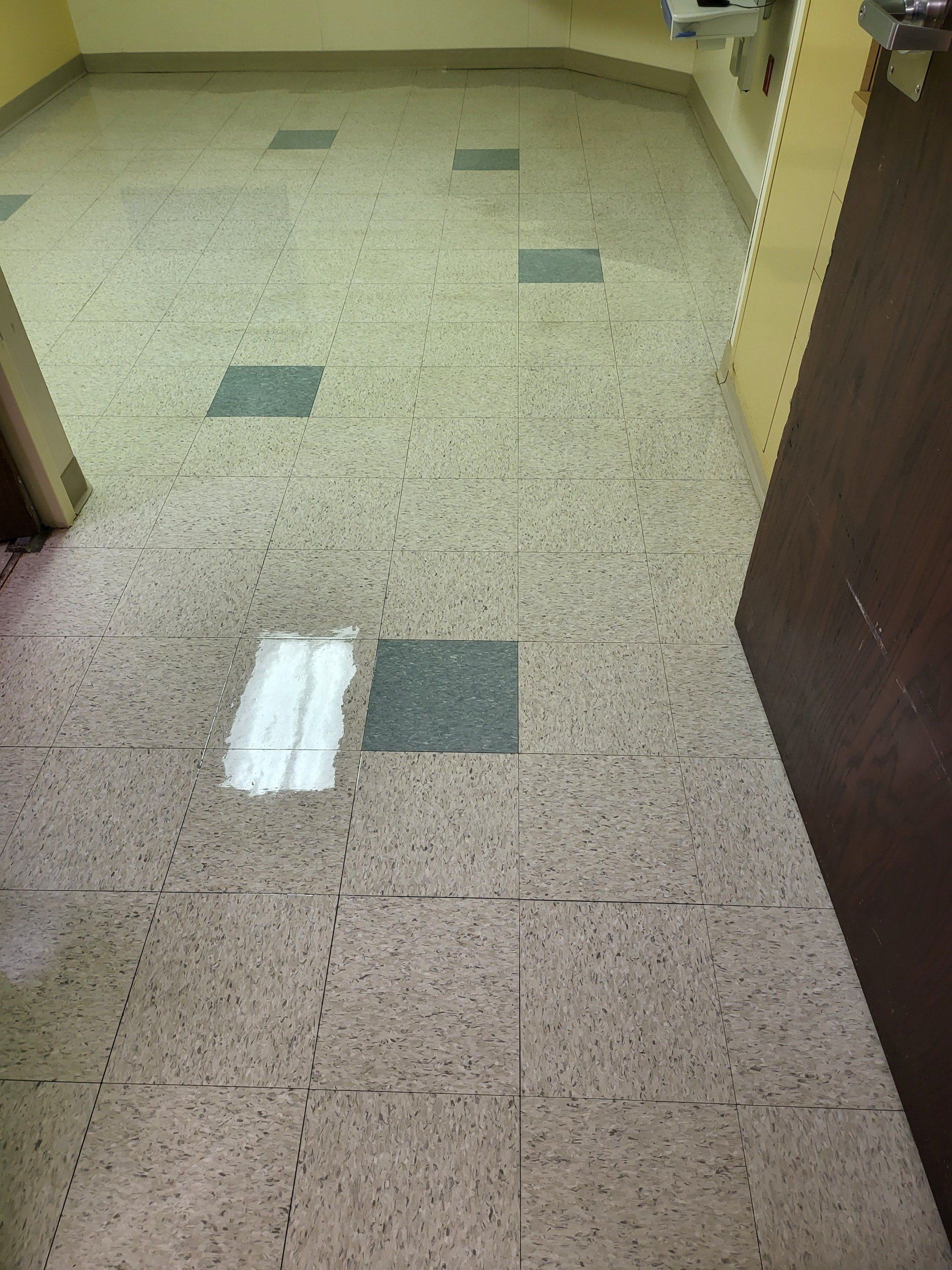 A room with a tiled floor and a door.