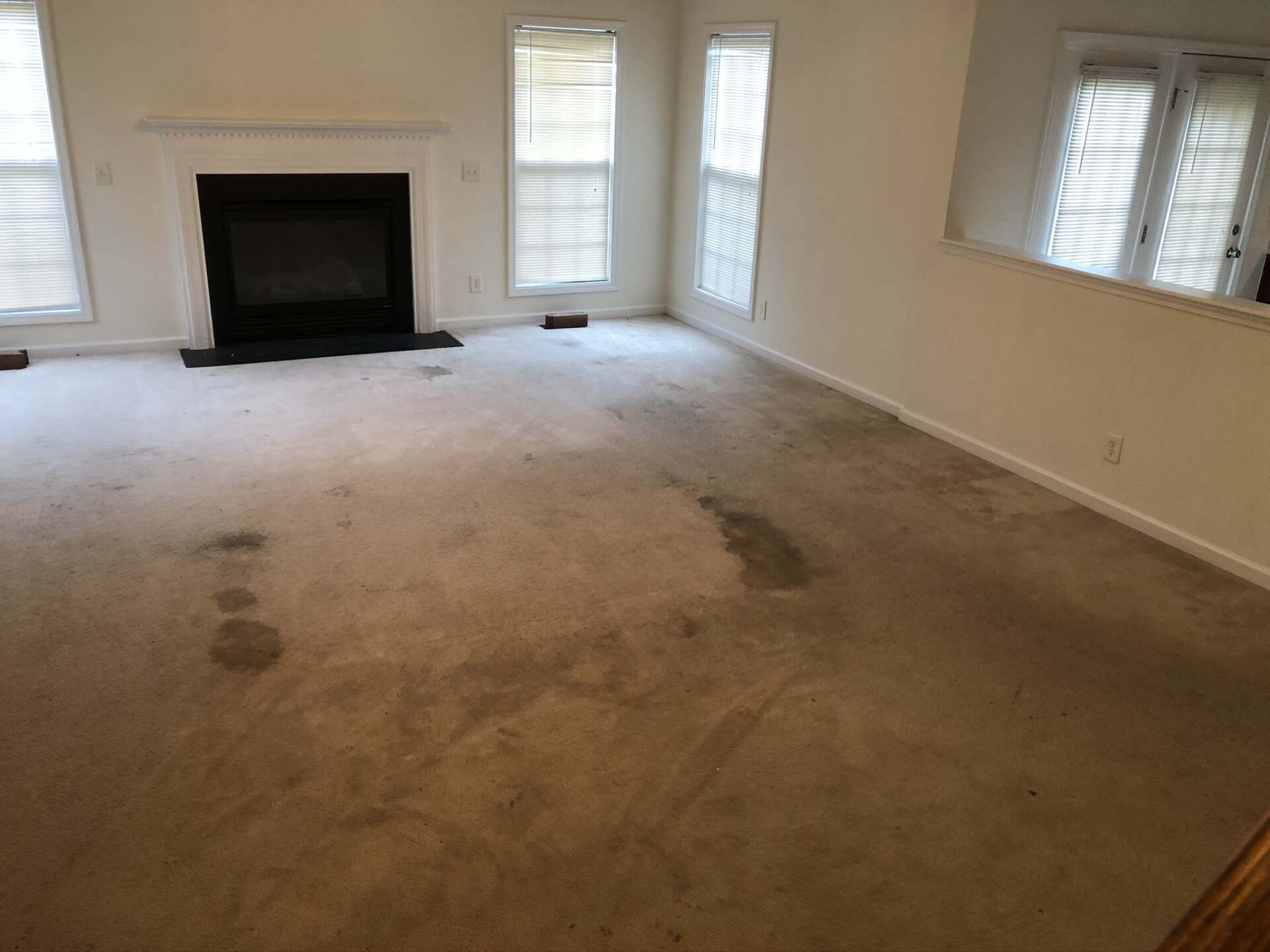 There is a fireplace in the middle of the living room.