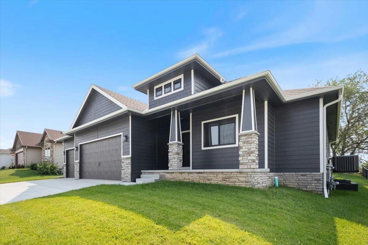 a large house with a lot of windows and a large garage .