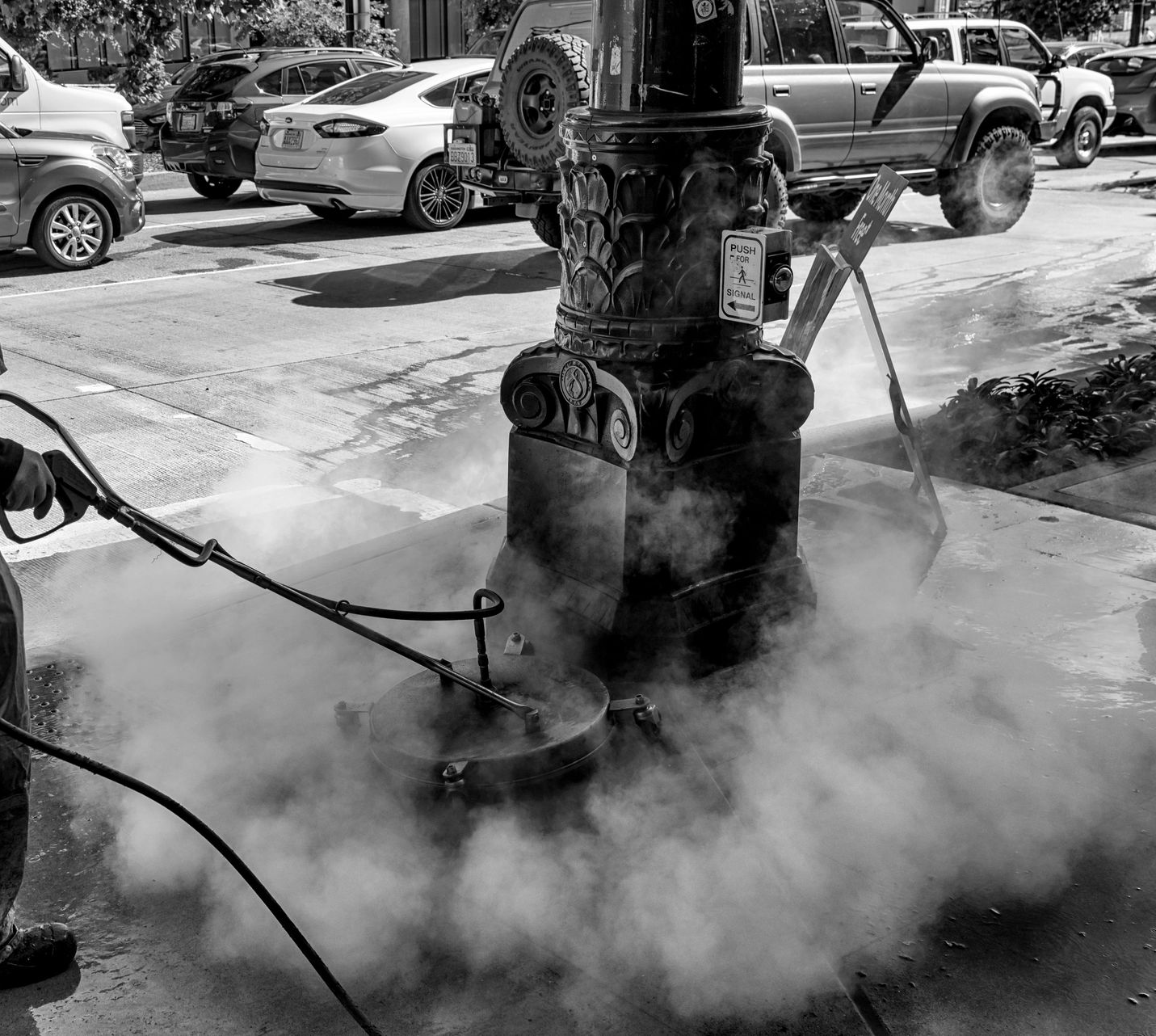 Man pressuring washing sidewalk