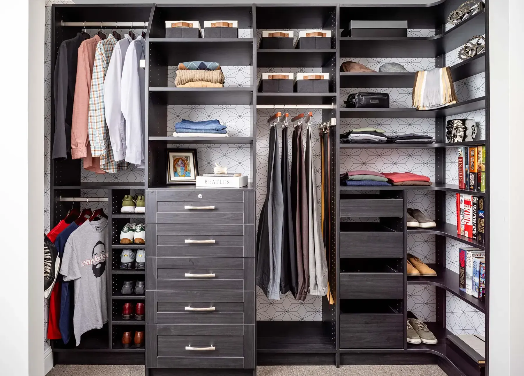 Walk-in closet with shelves, hanging clothes, drawers, and organized storage bins.