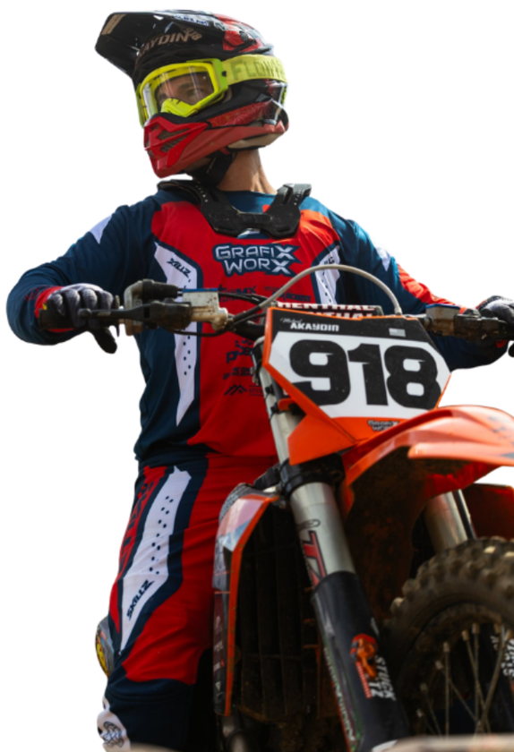 Motocross rider in red and blue gear on an orange dirt bike, wearing number 918.