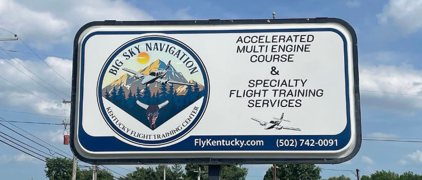 Bill's Navigation sign for accelerated multi-engine, SP & fishing charter training under a cloudy sky