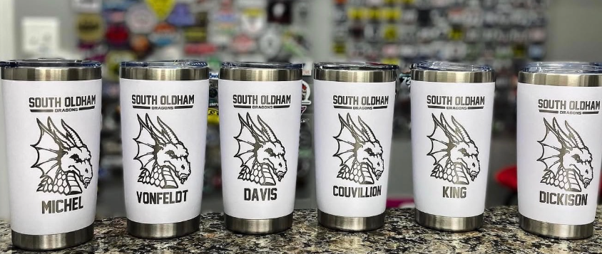 Six illustrated white tumblers lined up on a countertop, each labeled with a different name and animal icon.