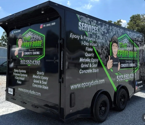 Black service trailer with green graphics advertising pressure washing and junk removal services.