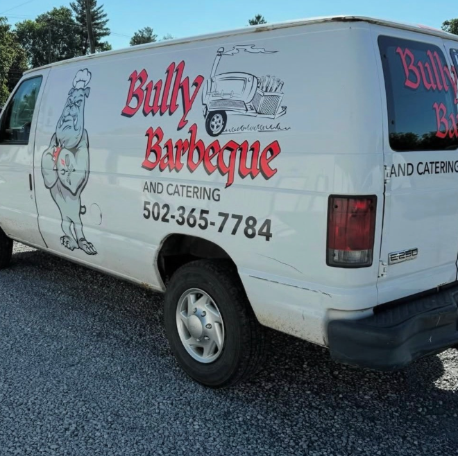 White Bully Barbeque catering van with red lettering and logo parked on gravel