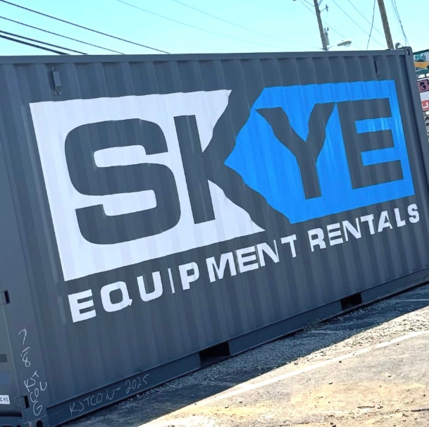 SKYE Equipment Rentals logo on a dark shipping container, with white and blue lettering.