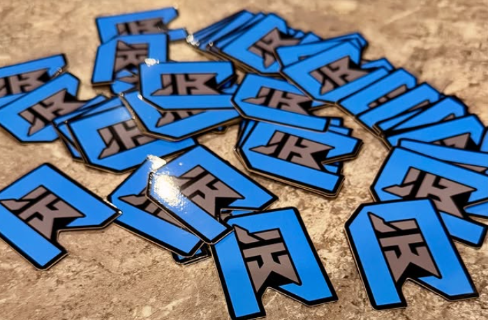 Scattered blue-and-black 3D letters on a textured tan surface