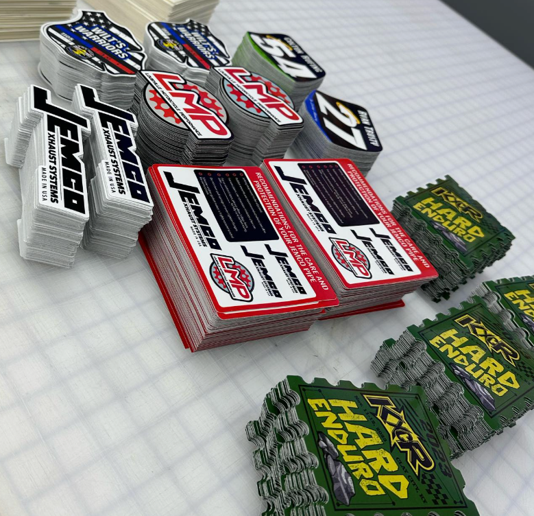 Assorted colorful embroidered patches stacked on a light grid surface