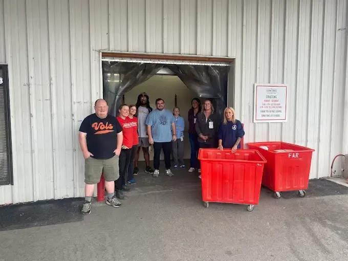 A group of people are standing in front of a building.