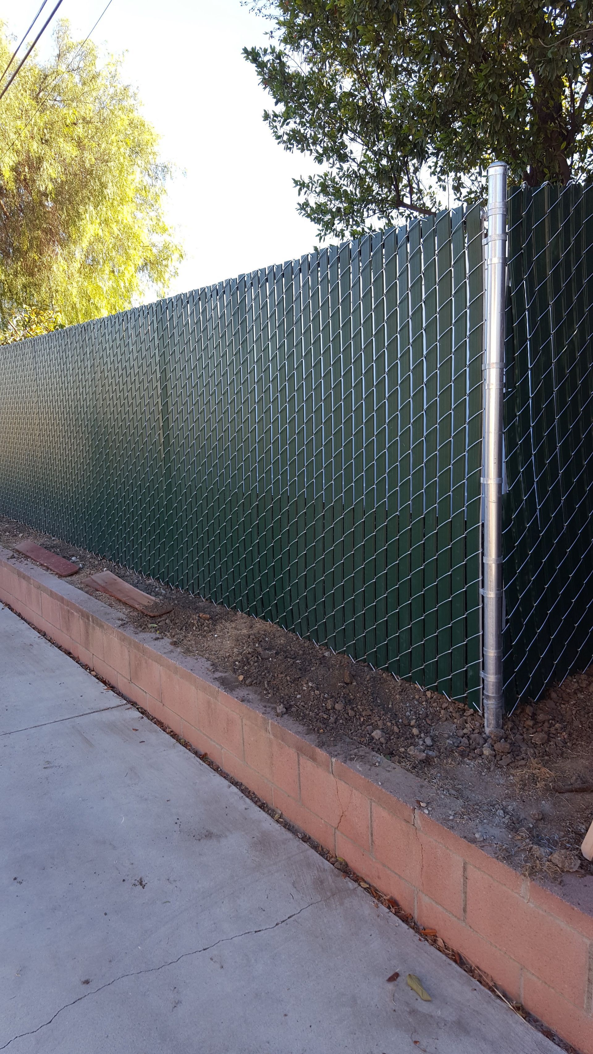 Privacy slat fencing installed along a residential side yard