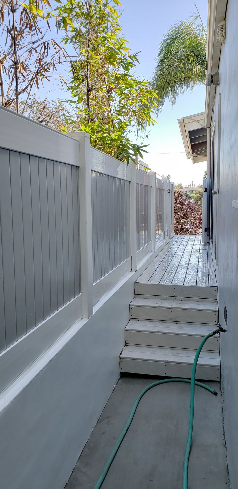 White vinyl fence bordering a residential property