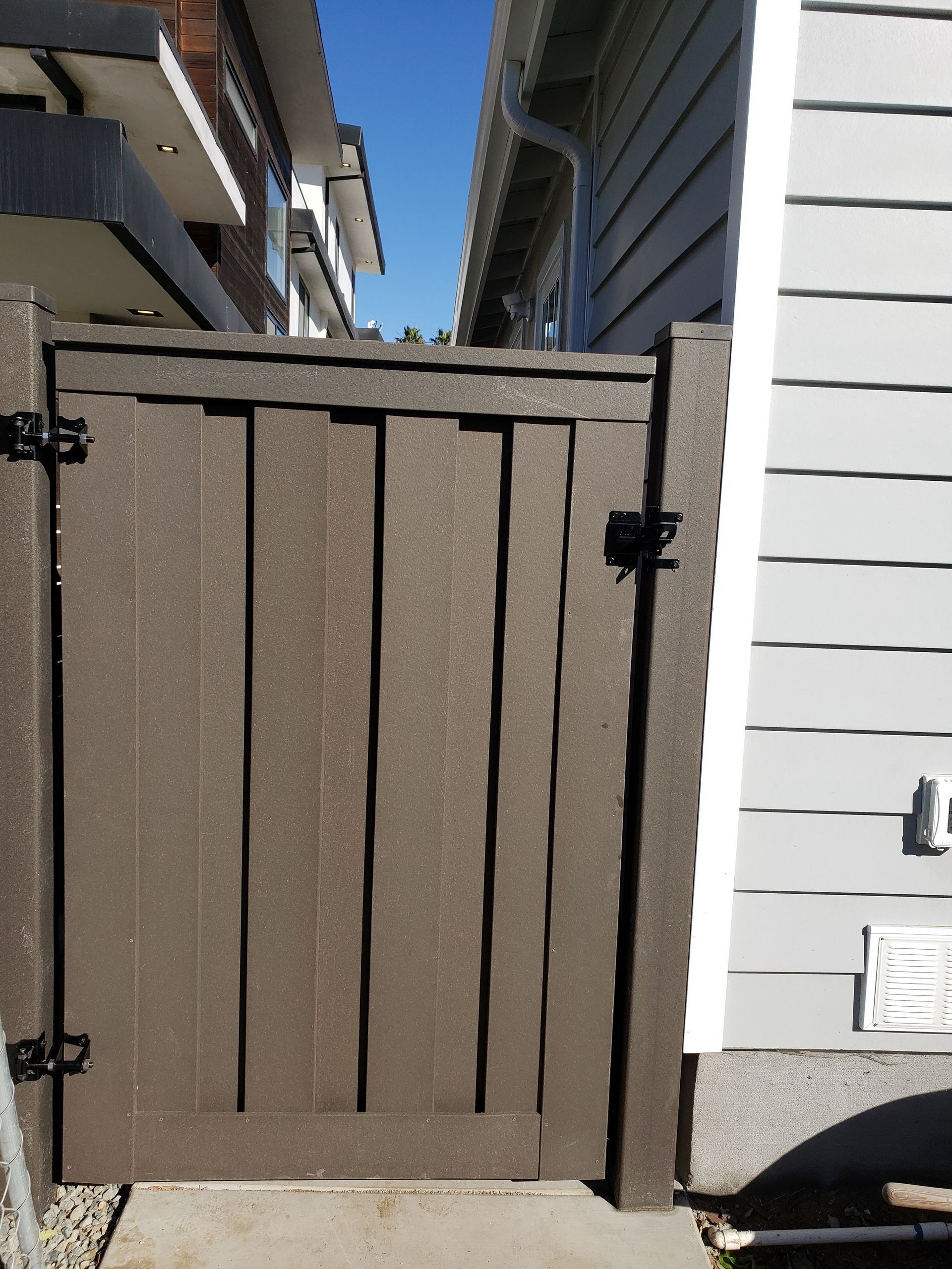 Trex composite fence installed along a residential side yard