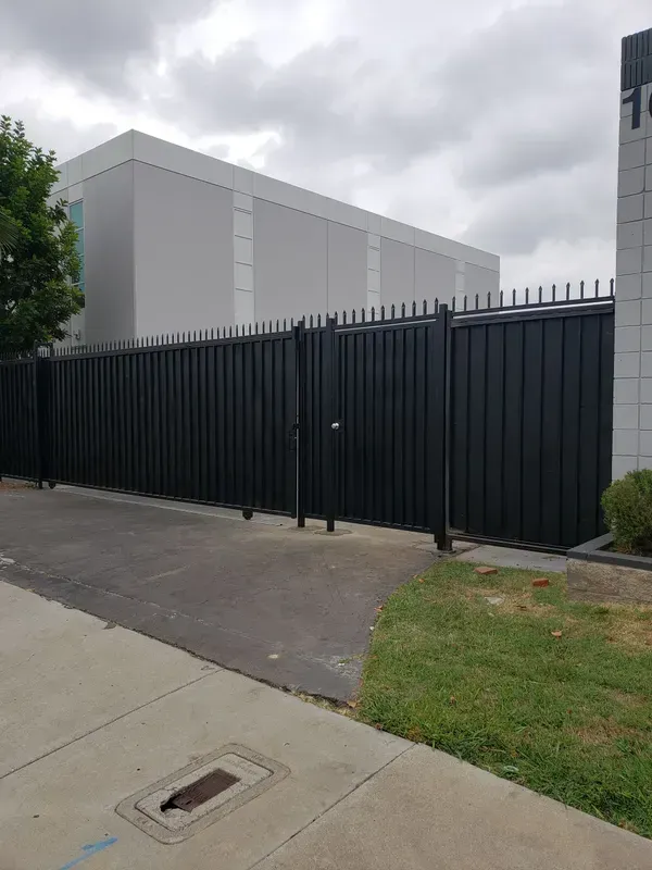 Black iron security gate installed at a building entrance