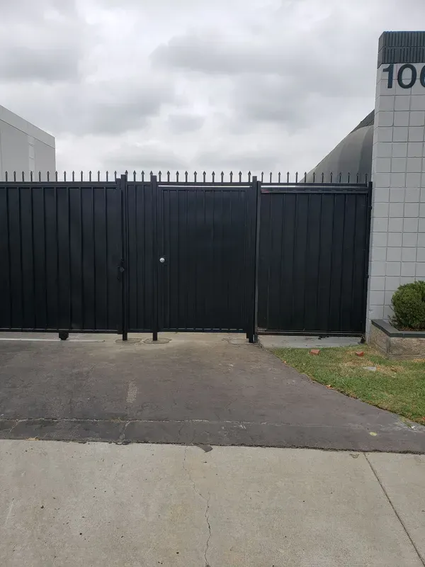 Black wrought iron security gate installed at a building entrance
