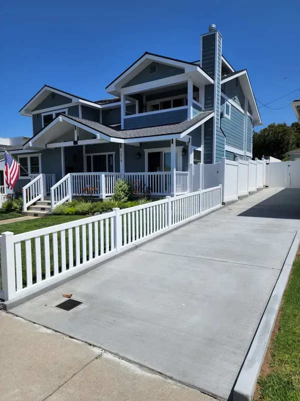 White vinyl privacy fence bordering a property line