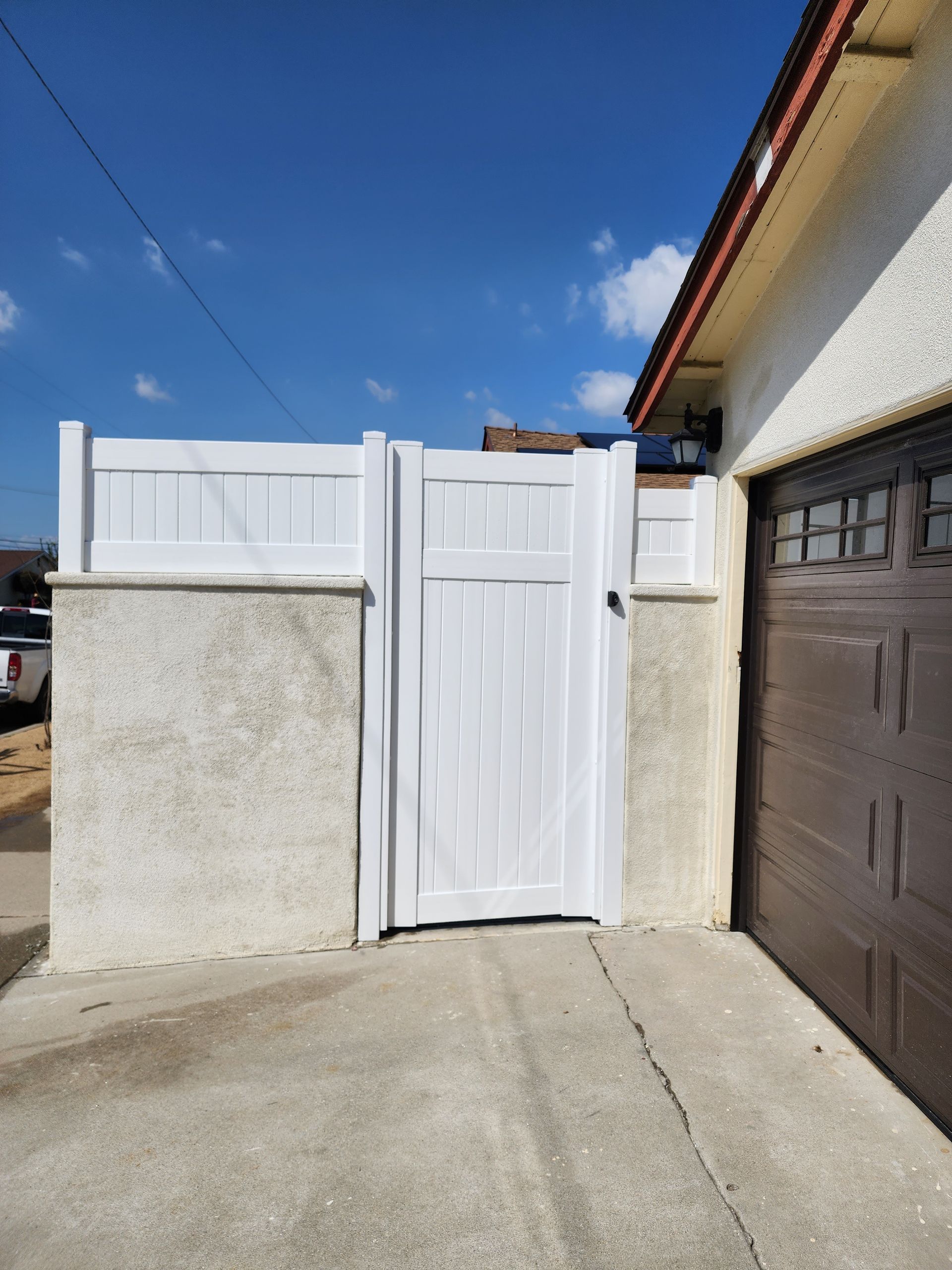 White vinyl fence installed for a residential backyard