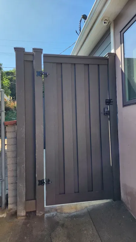Dark brown Trex composite gate with black hardware installed