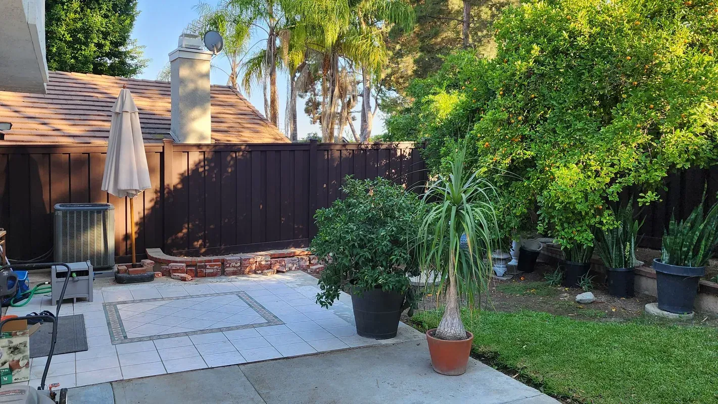 Trex composite fence lining a landscaped Los Angeles backyard patio