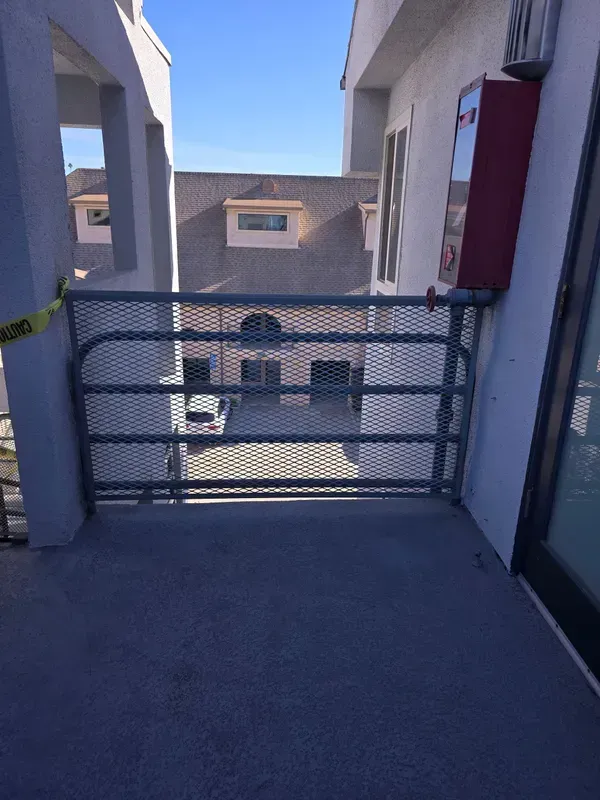 Wrought iron gate overlooking a Los Angeles apartment courtyard