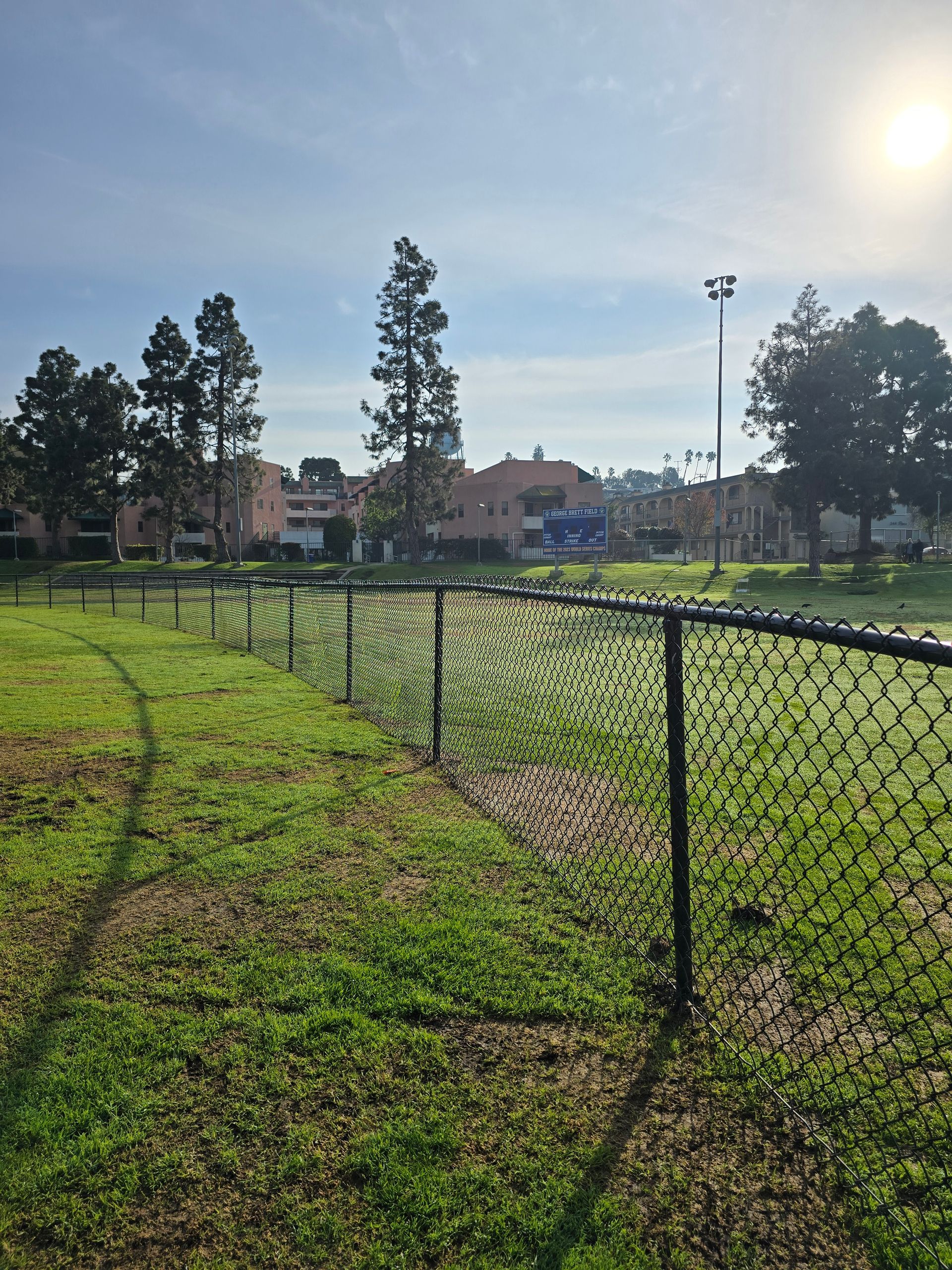Chain-link fence with gate securing a residential driveway